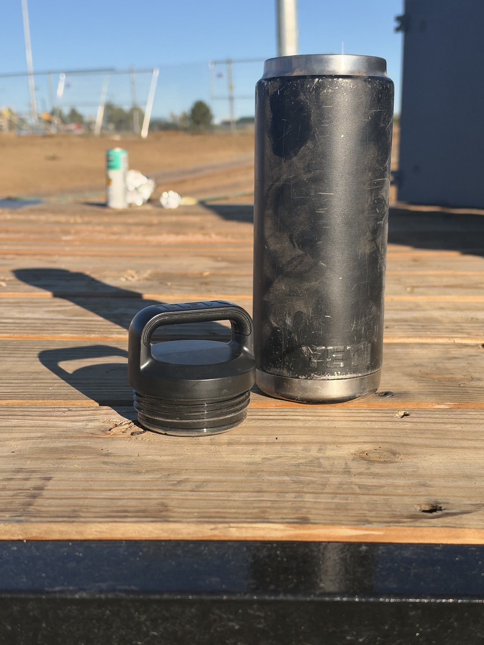 Case 01 bottle standing beside its removed cap, photographed as-is